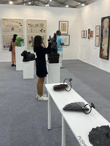 A visitor photographing a sculpture by Gopinath S.