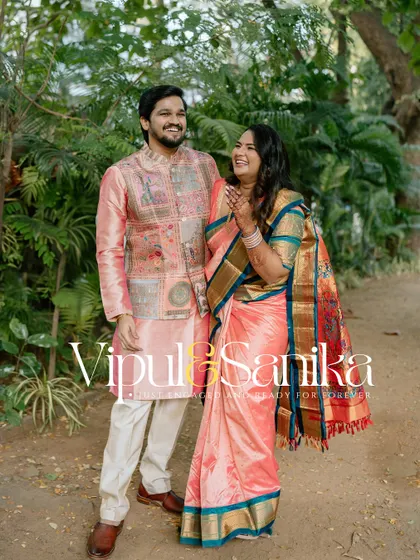 A full-length portrait of a couple smiling happily, with their names overlaid in a stylish font. This is a great example of a personalized save-the-date photo.