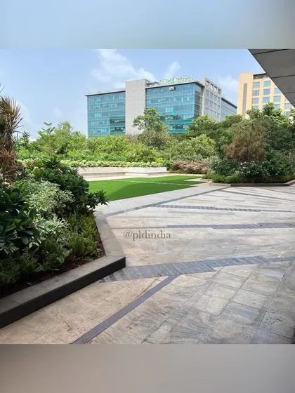 This perspective shows how the landscaped area integrates with the surrounding office buildings. The design provides a green, park-like view that enhances the work environment for everyone inside.