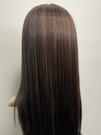 The back view of a mono base hairpiece with subtle highlights. This shows the smooth texture and expert coloring that we can achieve to match your desired style.