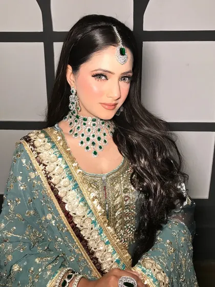 A beautiful portrait showing the full effect of the sleek hair and statement jewelry.