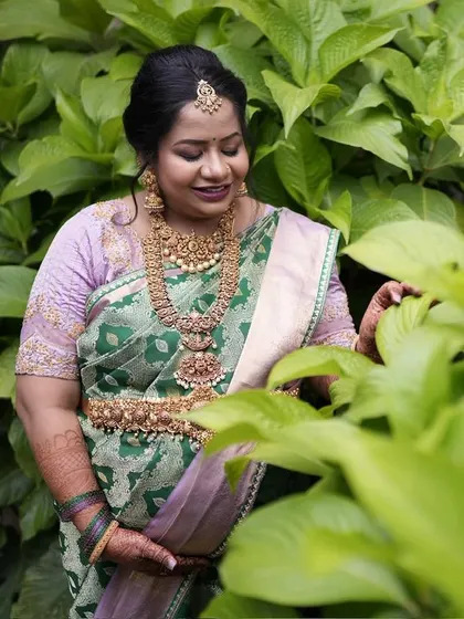 Another beautiful angle of Pavithra's baby shower look, showcasing the intricate patterns and rich texture of the handwoven silk.