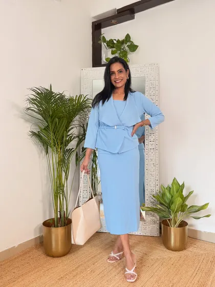 This beautiful powder blue dress with a belted shrug is a very chic and feminine office look. The color is soothing and the silhouette is very flattering.