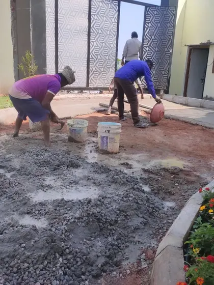 My team mixing concrete for setting pavers and garden borders. This foundational work is crucial for a long-lasting and professional hardscape design.