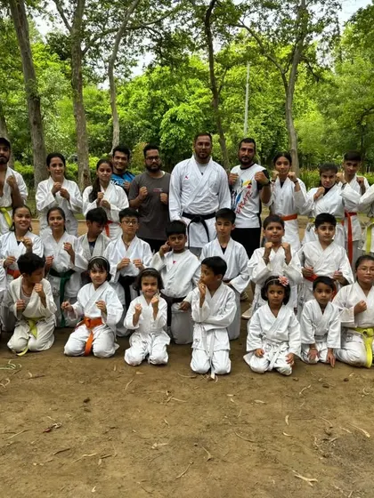 The full group of kids and adults who participated in our outdoor belt test. This is what our community looks like: all ages, training together.