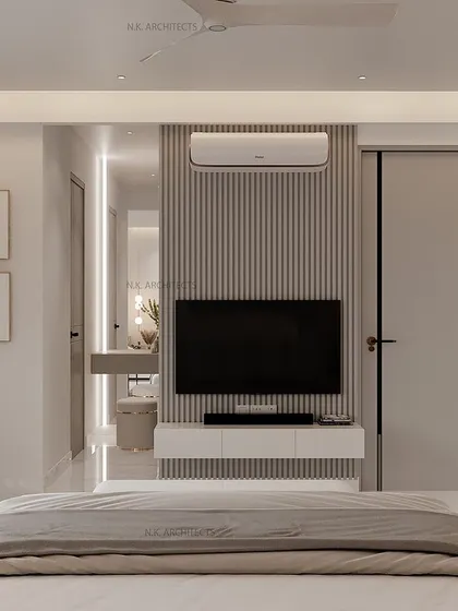 Another perspective of the minimalist grey and white bedroom, showing the dressing area integrated into the design. The fluted panels and clean lines provide a calm and organized feel.