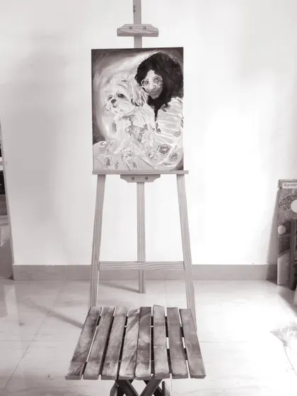 Another view of the completed black and white commissioned portrait on the easel. Creating these pieces provides joy to my clients while also being a self nurturing and calming process for me.
