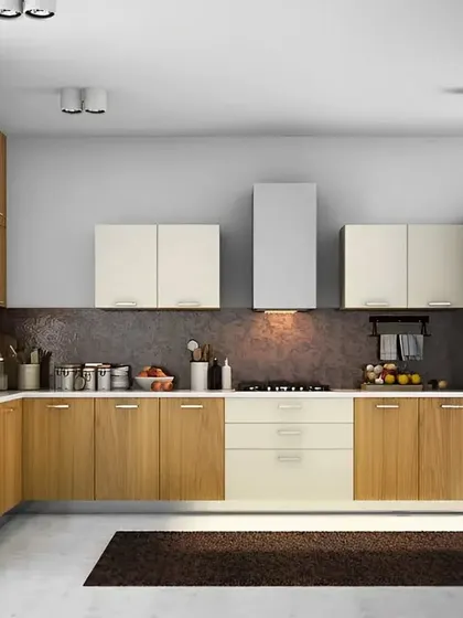 A two-tone modular kitchen with wood and cream cabinets. This design shows how we integrate appliances like the refrigerator and chimney seamlessly into the cabinetry for a clean, cohesive look.