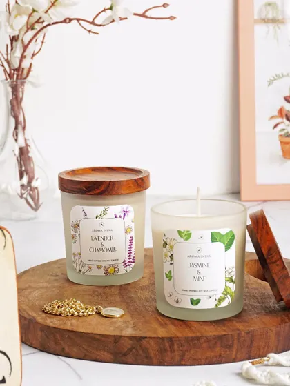 A duo of our frosted glass candles, featuring Lavender & Chamomile and Jasmine & Mint scents. The reusable Indian Rosewood lids add a touch of natural elegance to the minimalist design.