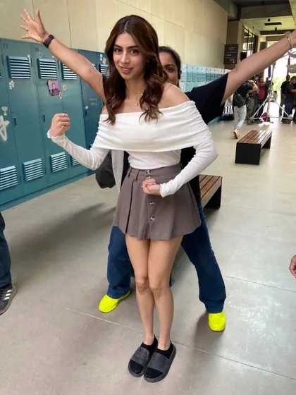 A playful moment with Khushi Kapoor behind the scenes. Her character's style was a mix of cute and preppy, like this off-shoulder top and mini skirt combo.