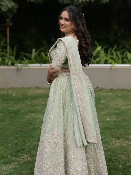 Vidhi looking back with a smile. Her soft glam makeup and the beautiful pastel green lehenga are a match made in heaven.