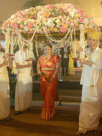 The bride's entry under a 'phoolon ki chadar' is a classic and beautiful tradition. We designed this one with a dense canopy of pastel flowers and pearl strings for a delicate and royal look.