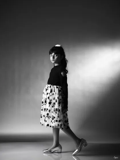 A dynamic black and white shot capturing movement and attitude. This portrait shows Pahal in motion, adding a sense of story and personality to her kids' portfolio.
