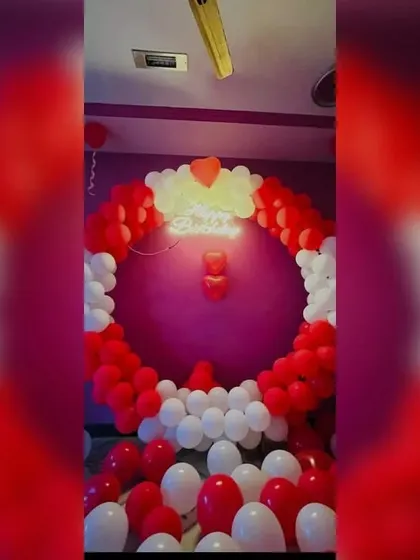A bold and romantic room decoration using a red and white balloon ring, perfect for an anniversary or a special birthday surprise.