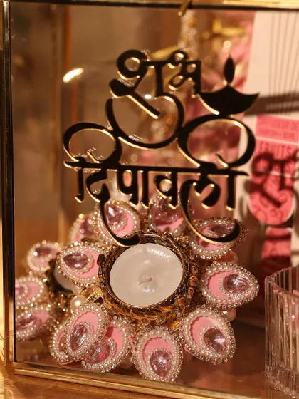 A detailed view of the jeweled pink T-light holder, a standout piece in this hamper.