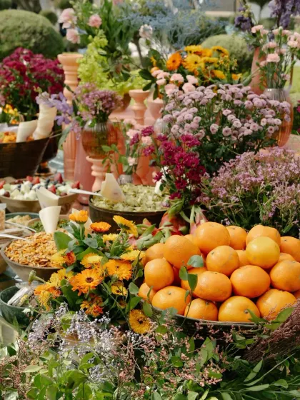 A vibrant display of oranges and flowers on the grazing table, adding a fresh and organic element to the decor.