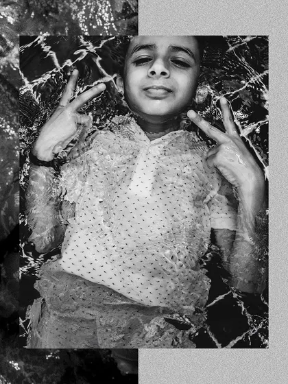 A cool black and white shot of a young guest floating in the pool, capturing the relaxed vibe of the party.