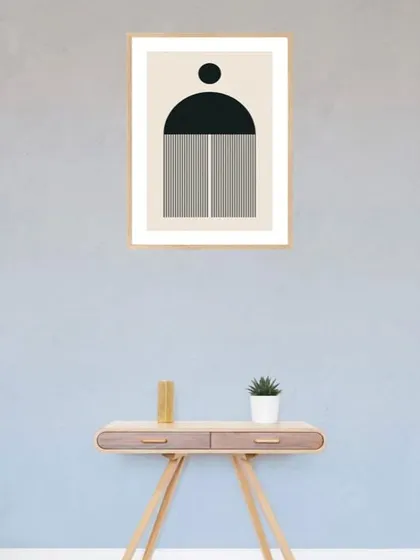 This single framed art print features a bold, geometric shape in black and white. The minimalist design is perfect for adding a touch of modern, graphic art to a console table or entryway.