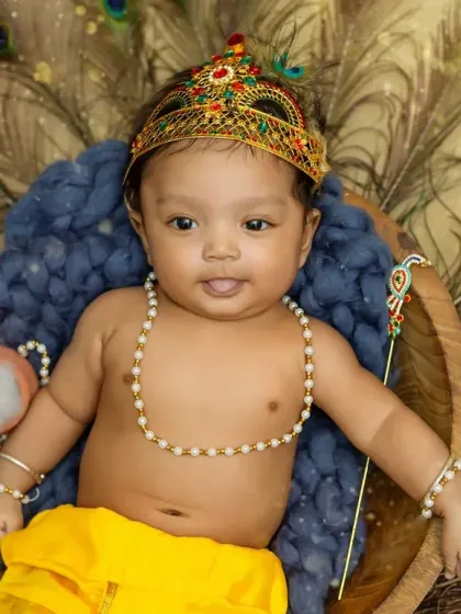 This little Krishna is looking right at the camera with such a curious and cute expression.