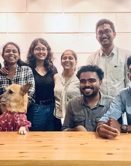 Glimpses of our team at the studio. We foster a collaborative and fun environment where ideas are shared openly, often with our furry studio manager keeping a watchful eye.