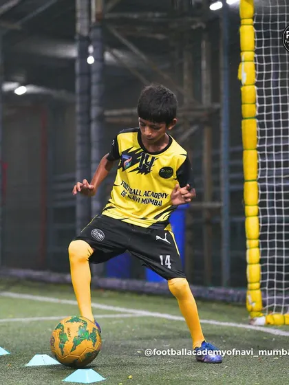 A player works on his close control, maneuvering the ball around cones. These drills are crucial for developing the technical skills needed in tight spaces.