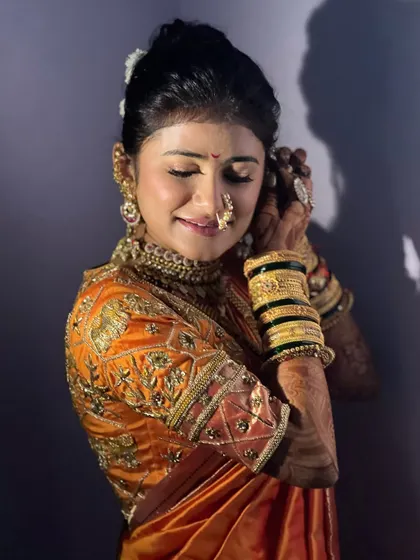 A bride getting ready on her wedding day. The makeup is soft and elegant, designed to make her feel confident and beautiful.