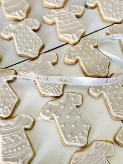 A whole tray of my baby onesie cookies, ready for a baby shower. The neutral color palette is elegant and sweet.