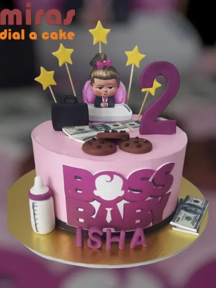 For the little girl who's the boss! This pink Boss Baby cake is perfect for a second birthday, featuring a girl Boss Baby topper, edible money, and a baby bottle.