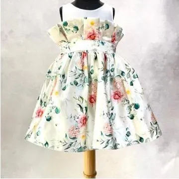 A back view of the "Floral Grace" dress, showing the paper-bag waist detail and the full, pleated skirt perfect for twirling.