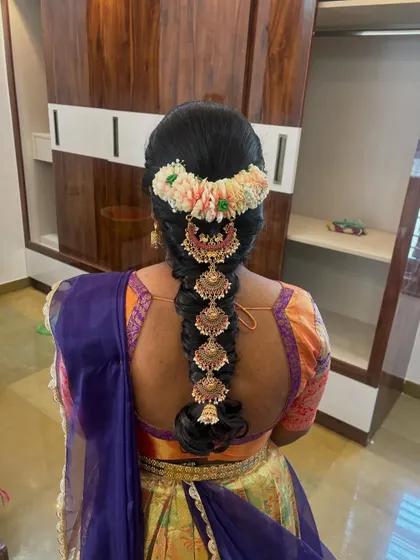A bubble braid style where each section is decorated with a traditional 'Jada Billa' ornament.