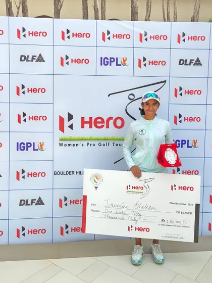 Jasmine Shekar holds her winner's check and trophy after a spectacular victory at the 15th Leg of the 2024 Hero Women’s Pro Golf Tour. Her bogey-free final round was a showcase of skill and composure under pressure.