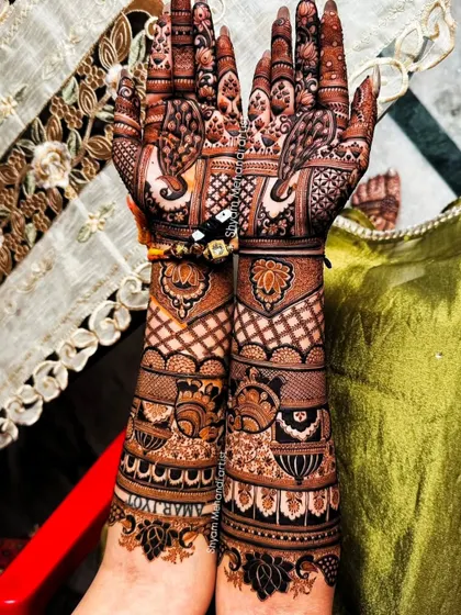 A full view of the previous design, showcasing the dense and detailed work from palms to elbows.