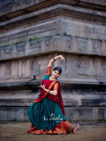 A collection of poses from a cherished photoshoot. The combination of the traditional half-saree and the rustic temple background creates a timeless and elegant look.
