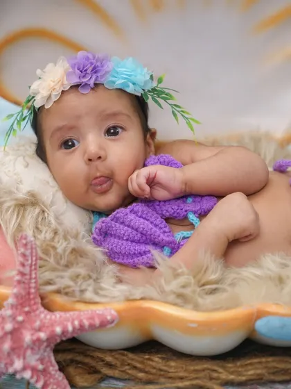 A playful moment as the baby sticks out her tongue. These little personality quirks make for the best photos.