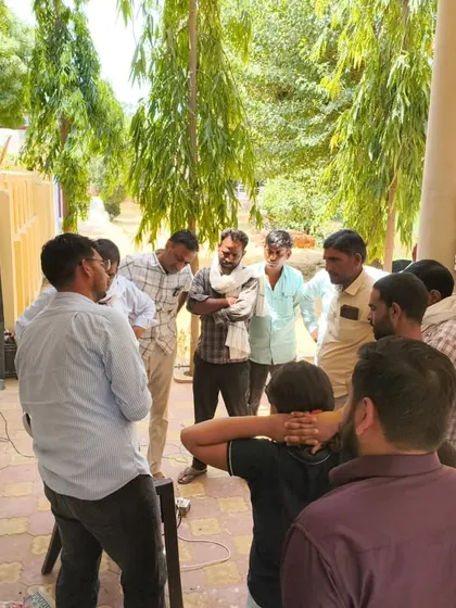 A group of farmers gathers around our demonstration setup during a village meeting. We encourage questions and discussions to ensure everyone leaves with a clear understanding of how our smart irrigation can be implemented on their own farms.