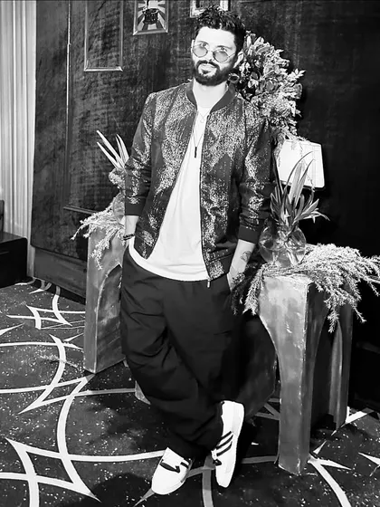 A cool, edgy look in a sequined bomber jacket. This black and white shot adds a timeless, classic feel.
