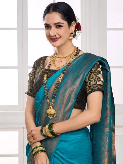 A model wearing a traditional Maharashtrian mangalsutra and gold jewellery set with a blue silk saree, ideal for regional and festive collections.