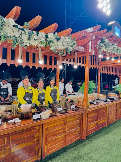 A wide shot of the entire Japanese food station, housed in a beautiful wooden pergola structure.