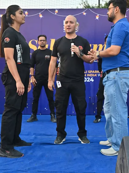Explaining the nuances of a defensive stance to a volunteer and my instructor. Proper body mechanics are the foundation of effective self-defense, allowing you to generate power and maintain balance.