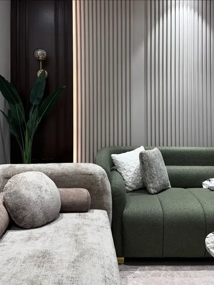 A detail shot of the custom-upholstered sofas in textured fabrics. The round bolster pillows and soft cushions were designed for ultimate comfort and style.