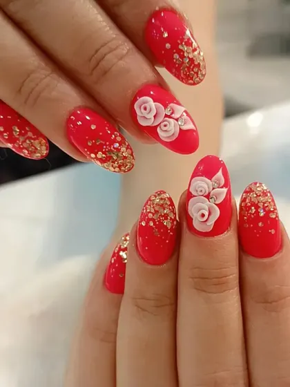 This bridal design features a bright red base with gold glitter accents and beautifully sculpted 3D roses on the ring fingers.