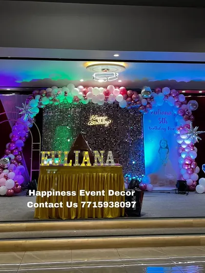 A full stage view of the premium princess birthday setup. The decor includes a large sequin backdrop, balloon arches, and cutouts of four different Disney princesses.