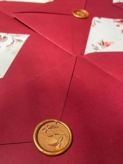 A closer look at the details from this beautiful wedding suite. The design included multiple inserts with event details, custom floral envelope liners, and a personalized wax seal with the couple's initials.
