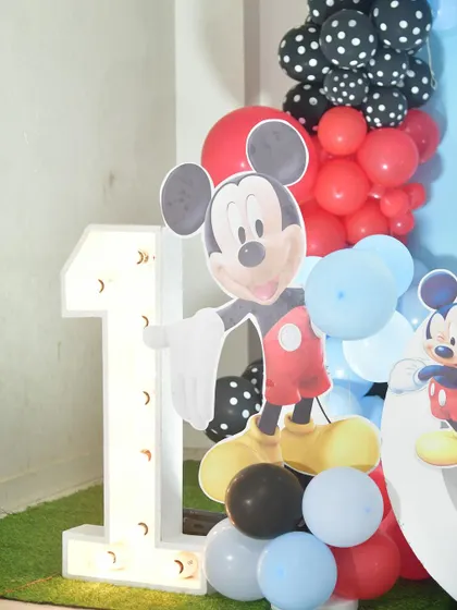 A detail of the Mickey Mouse decor, with a character cutout next to the light-up number '1'.