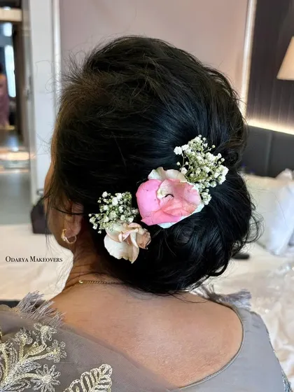 A soft and romantic floral bun for a grandmother. It's a graceful and age-appropriate hairstyle that looks beautiful.