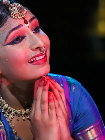 A close-up of Gowri's expressive face. The makeup, or aaharya, helps to accentuate the dancer's features and expressions on stage.