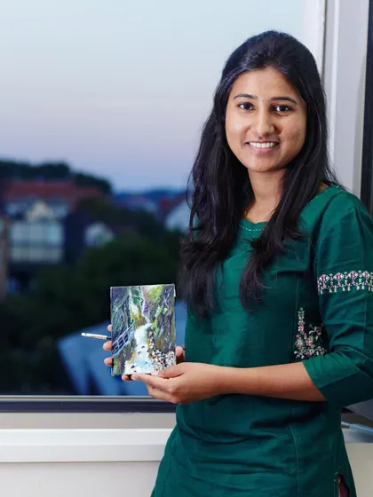 Me proudly displaying the completed painting from my Germany travel memory.