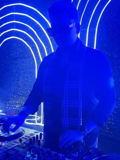 A silhouette shot against the neon backdrop, highlighting the artistic side of DJing.