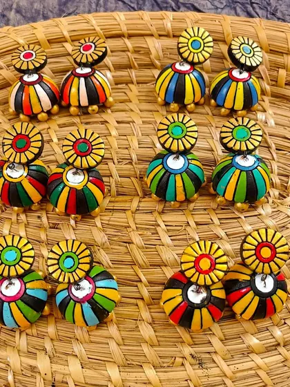 These colorful striped jhumkas are fun and vibrant. The stud-and-jhumka combination is a classic style that is always in demand.