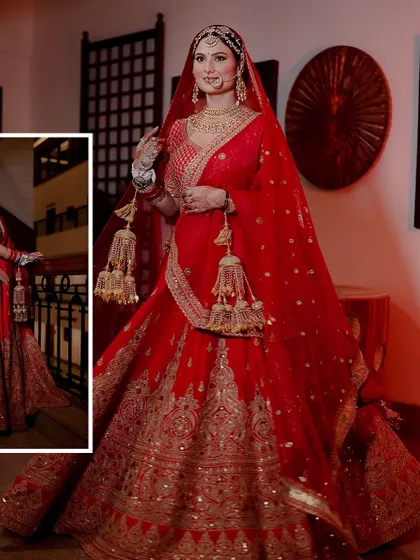 A full-length portrait of the bride, Aashi, showcasing her magnificent red and gold wedding lehenga.